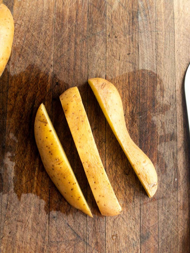 three strips of potato on a cutting board