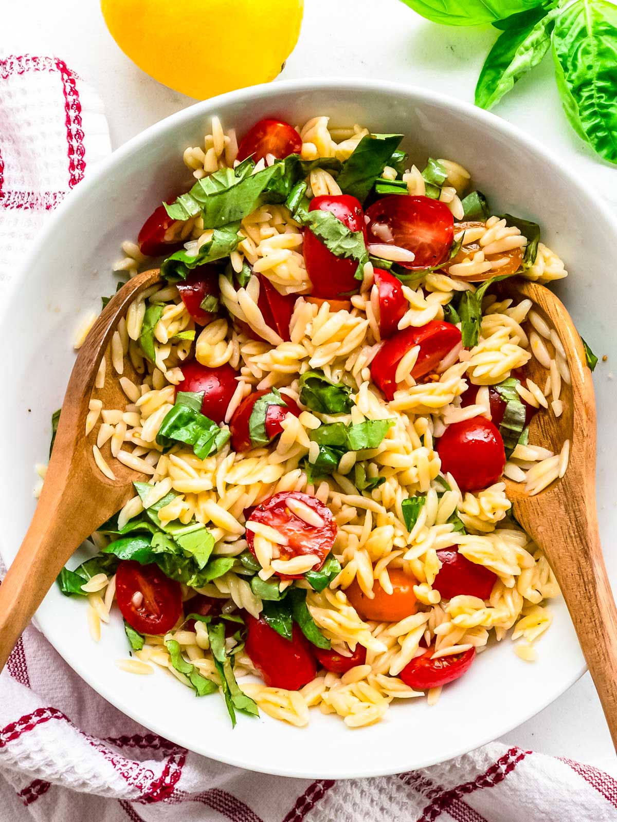 top view of orzo pasta salad with tomatoes and basil