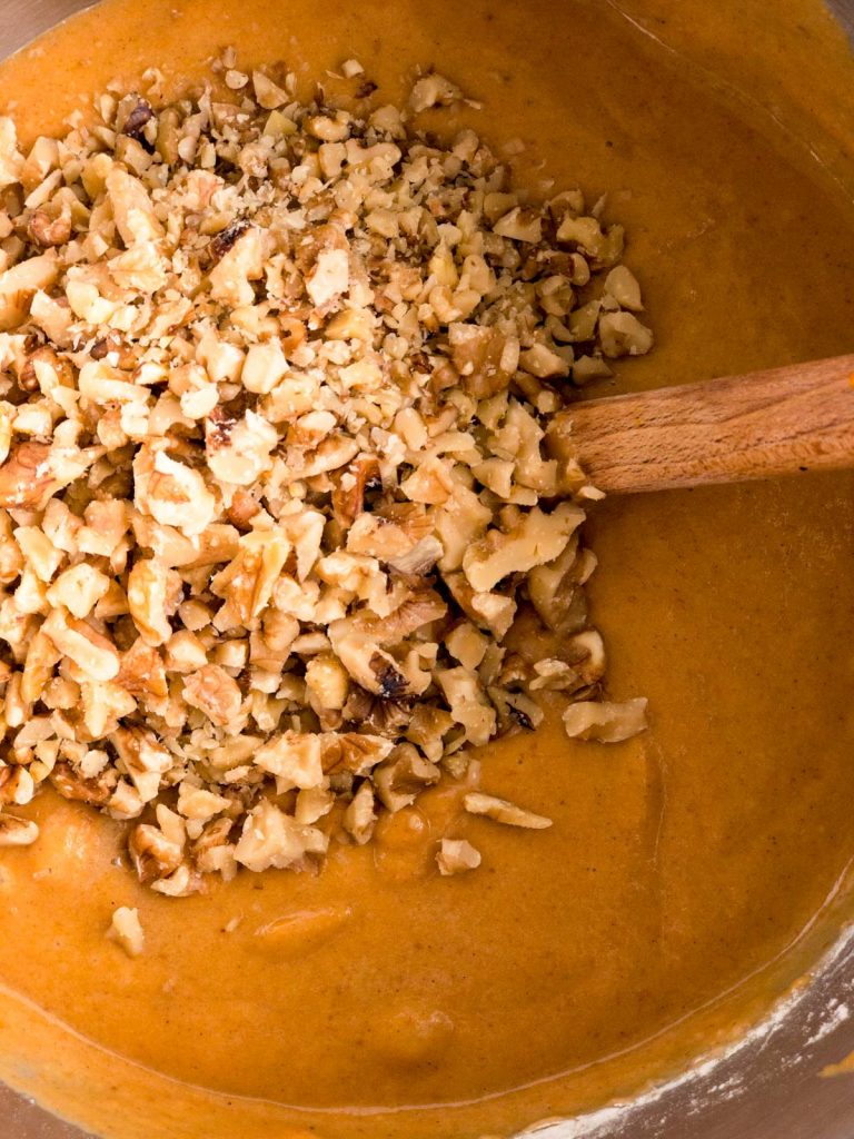 Walnuts on top of batter in a bowl