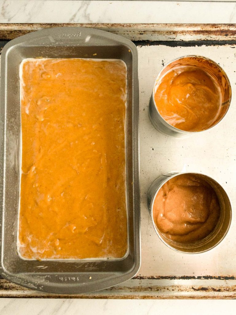 Pumpkin bread batter in loaf ban and soup cans