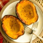 Roasted acorn squash halves on a plate