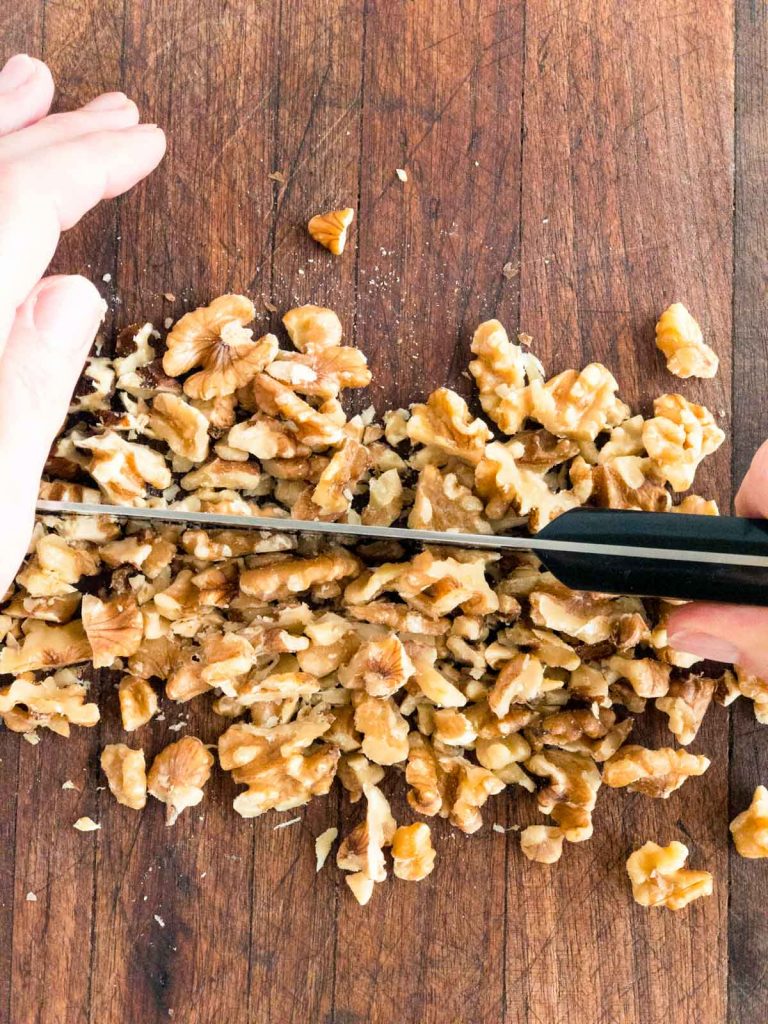 Chopping walnuts on a chopping board