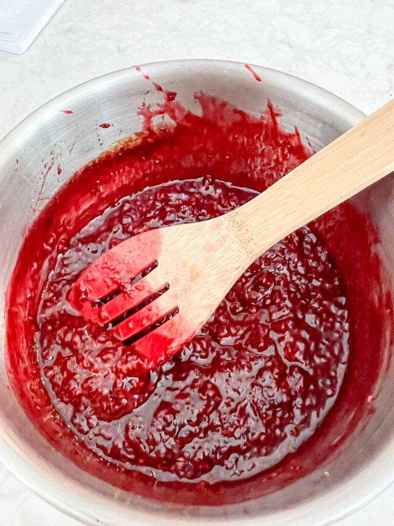 Cooked raspberry sauce in a sauce pan