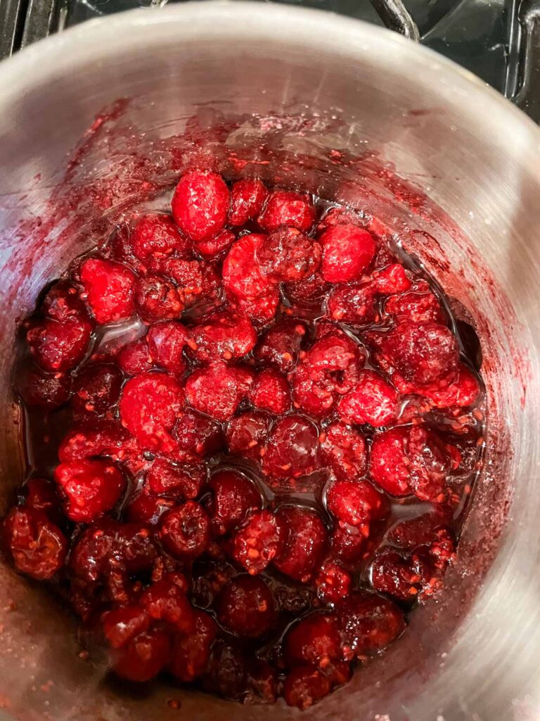 Raspberries cooking in a sauce pan