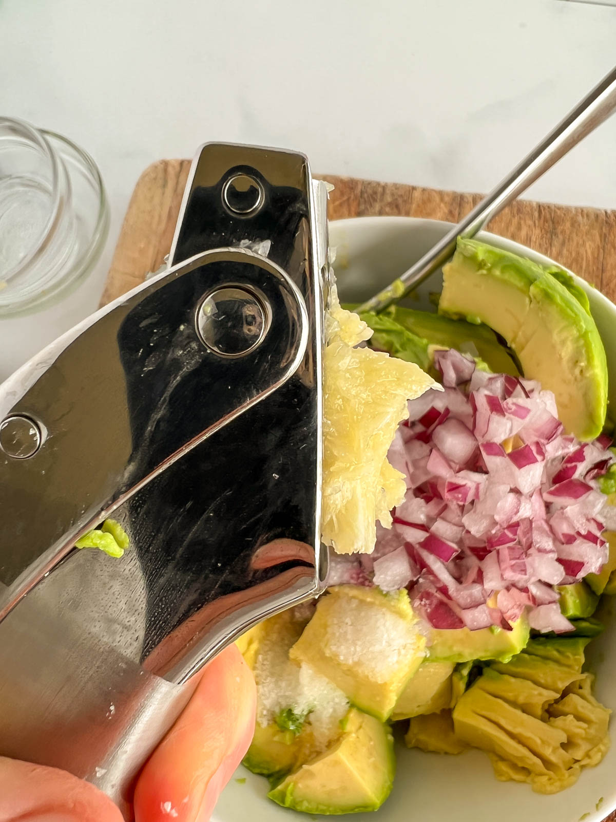 Pressing garlic in a garlic press