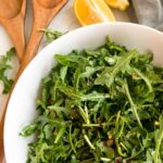 Arugula salad in a white bowl