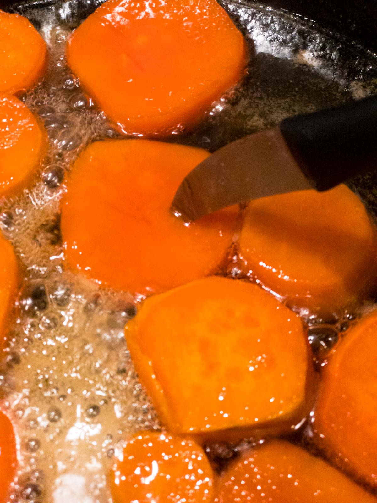 paring knife inserted into a sweet potato round 