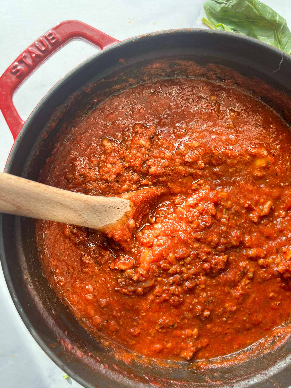 Cooked turkey meat sauce in a Dutch oven