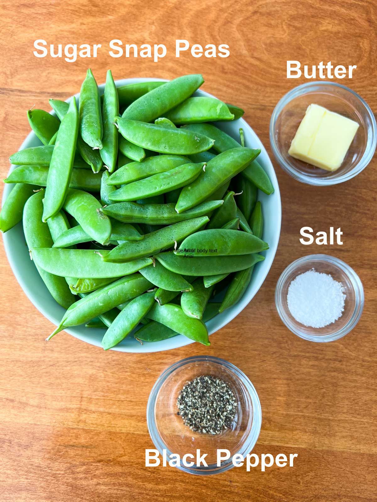 Raw Sugar snap peas in a bowl, butter in a glass bowl and salt and pepper in glass bowls.  