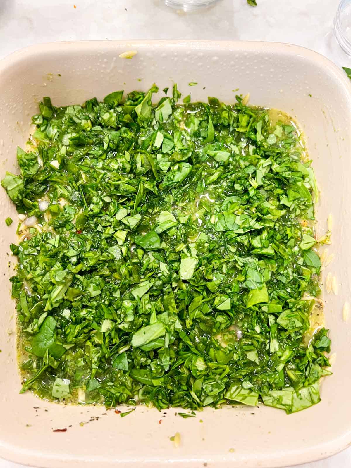 Chopped spinach on orzo mixture