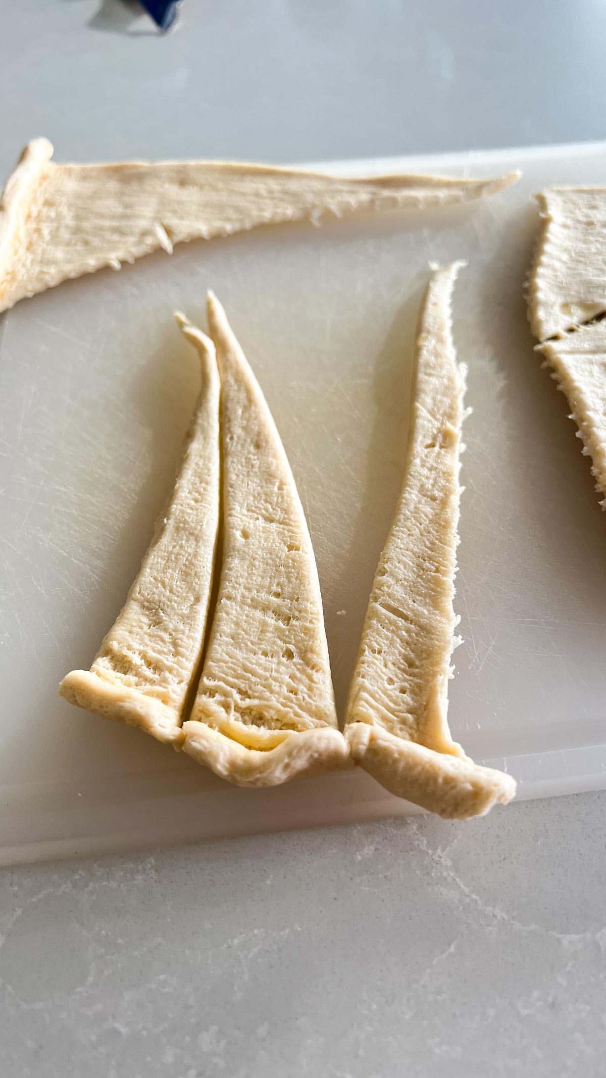 Crescent dough triangle cut into 3 strips